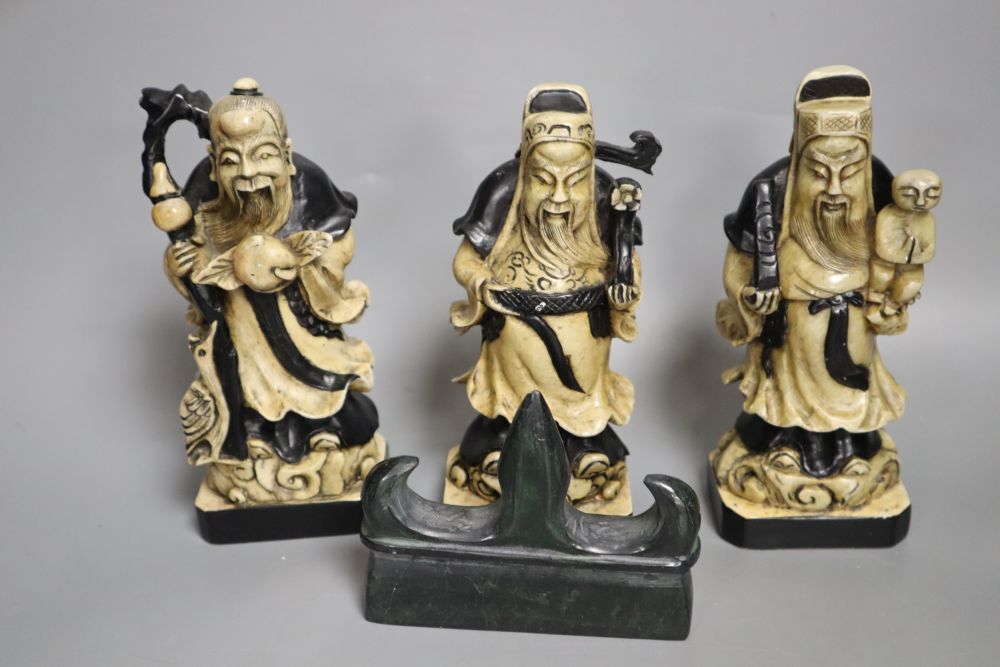A set of three Chinese soapstone figures of the Star Gods and a soapstone brush rest, tallest 16.5cm